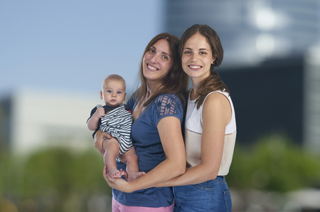 Lesbian love, young lesbian mothers with their baby. Homosexual familyの写真素材