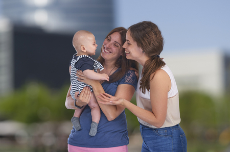 Homosexual family, young lesbian mothers with their baby. Lesbian loveの写真素材