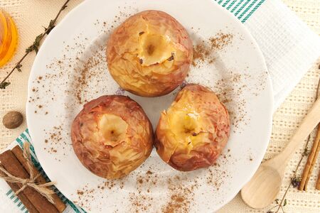 Baked apples in white plate on table. Top viewの写真素材