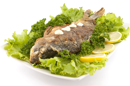 Roasted fish with fresh herbs and lemon. Selective focusの写真素材