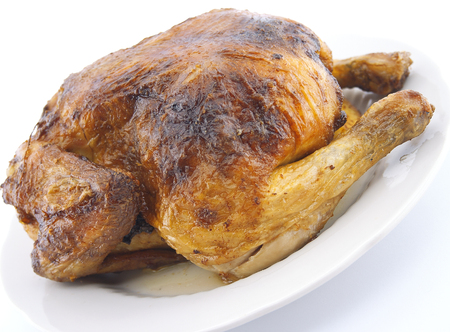 Whole roasted chicken on white background.の写真素材