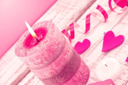 Composition with candle, gift box and hearts on white rustic wooden background. Valentine's Day and Mother's Day background. Toned image. Soft focus.の写真素材