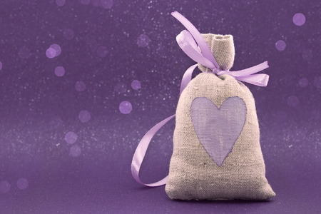 Bag with a painted heart on the shiny background. Valentine's Day and Mother's Day background. Love...