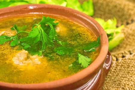 Soup with meatballs in ceramic bowl. Selective focus.の写真素材