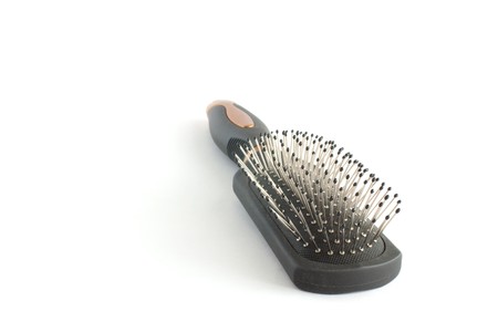 Black professional hairbrush isolated on whiteの写真素材