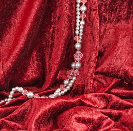 Red velvet and a string of beadsの写真素材