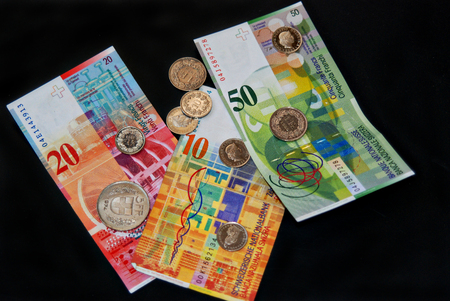 Swiss Franc money on  black background, coins and banknotesの写真素材
