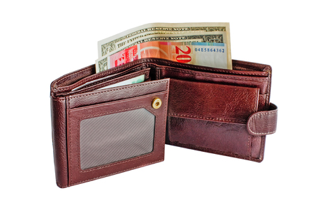 Open brown leather wallet with money isolated on white backgroundの写真素材