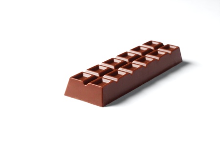 Bar of brown chocolate isolated on white background.の写真素材