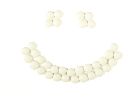 White tablets in the shape of smileyの写真素材