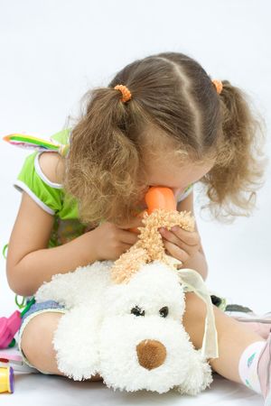 The girl plays in the doctor with toy toolsの写真素材