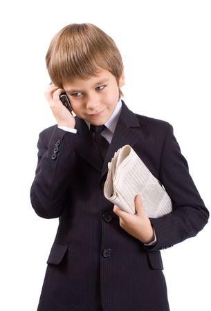 Boy in a business suit with a newspaper, isolated over whiteの写真素材