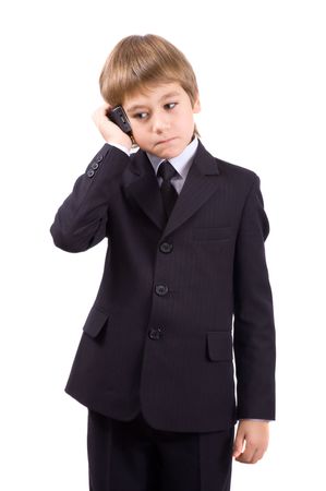 Boy in a business suit with a telephone, isolated over whiteの写真素材