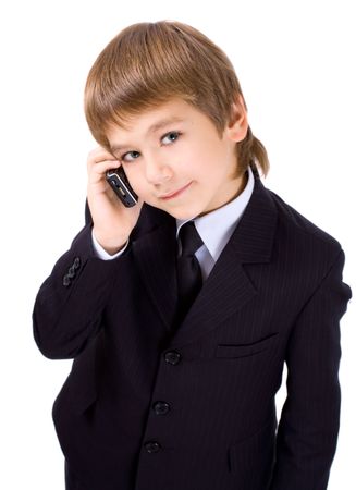 Boy in a business suit with a mobile telephone, isolated over whiteの写真素材