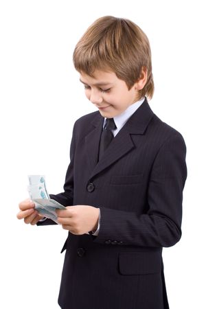 Boy in a business suit, holds  money in hands, isolated over whiteの写真素材