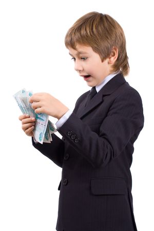 Boy in a business suit, holds  money in hands, isolated over whiteの写真素材