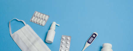Protective equipment against pandemic, coronavirus, top view Medical face mask, tablet plate, pills,...