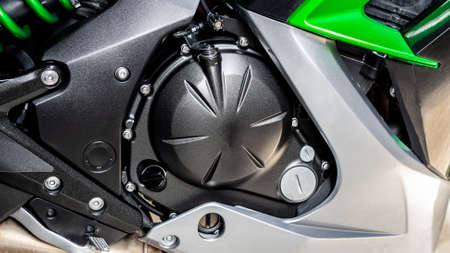Black cylinder of engine of motorcycle closeup. Part sport green bike, side view. Motorcycle...