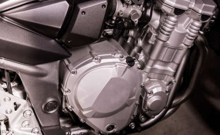 gray engine of motorcycle close-up. Sport silver-black bike, top side view. Motorcycle internal...