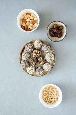 No bake sweets energy balls with hazelnuts, cashews, peanut butter and almond on the plate. Healthy...