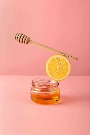 Equilibrium floating food balance with products honey and lemon for making drinks tea to prevent and treat colds and support the immune system. Alternative folk remedies medicine an anti-inflammatory.の写真素材