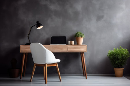 Wooden desk next to empty copy space gray stucco wall with items for work and chair, workplace at home or office. Generative AI.の素材