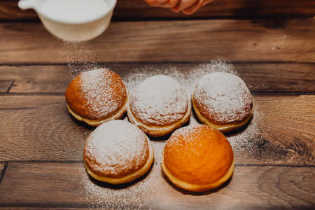 Fried carnival donuts, the so-called Krapfen, filled with apricot jam and sprinkled with sugar,...
