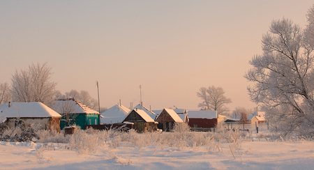 winter view of traditional wooden houses in Russiaの写真素材