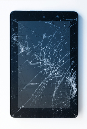 Picture of cracked display on a tablet isolated on white. Tablet with damaged screenの写真素材