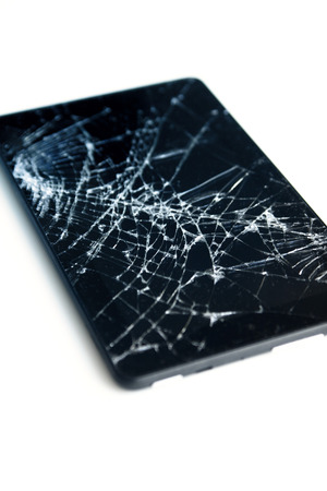 Picture of cracked display on a tablet isolated on white. Tablet with damaged screenの写真素材