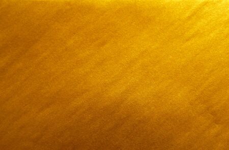 Gold paper background. Abstract golden background for Christmas holiday, banner, wedding invitation and greeting cards. Golden textureの写真素材