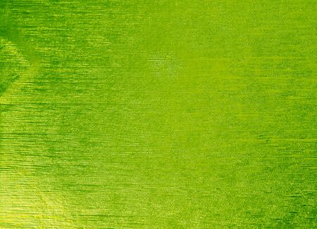 Shiny green leaf gold foil texture background. Glittering  background for Christmas holiday, banner, wedding invitation and greeting cards.の写真素材