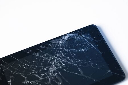 Photos of cracked display on a tablet  isolated on white. Tablet with damaged screen.の写真素材