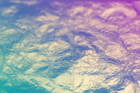 Shiny leaf golden foil wrinkled background suitable for any graphic design, poster, website, banner, greeting card, backgroundの写真素材