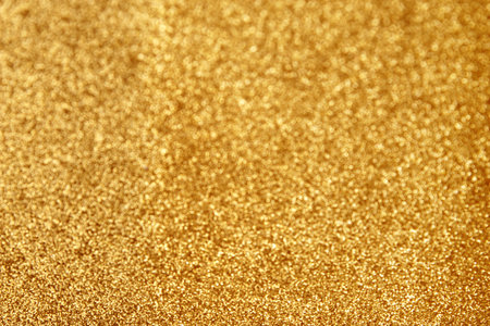 Gold glitter texture sparkling paper background. Abstract twinkled golden glittering background  with bokeh, defocused lights for Christmas holiday banner.  Flat lay mockup design. Horizontal line.の写真素材