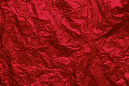 Red crumpled texture background. Abstract banner with shine red.  Flat lay mockup design. Craft paper texture sheet abstract background, wrapping texture.の写真素材