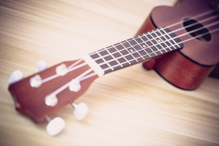 Closeup shot of ukulele on the wooden background.の写真素材