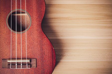 Ukulele on the wooden background with blank copy space.の写真素材