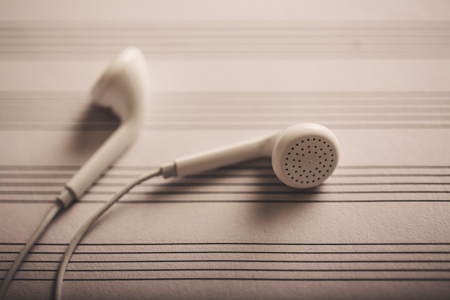 Headphones on the blank music notes paperの写真素材