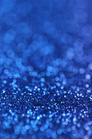 Abstract background of blue glittering defocused lights.の写真素材
