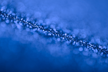 Abstract background of blue glittering defocused lights.の写真素材