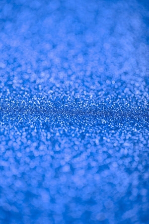 Abstract background of blue glittering defocused lights.の写真素材