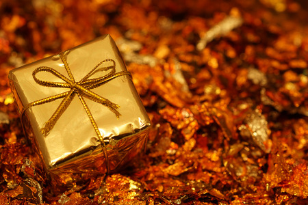 Golden decorative box on red background, template for postcard