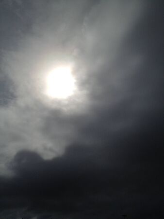 Sun breaking through a stormy skyの写真素材