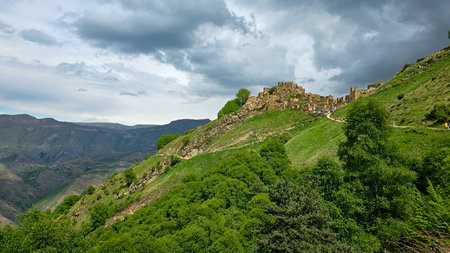 Ruins of a medieval castle on the slope of a mountain in Armenia.