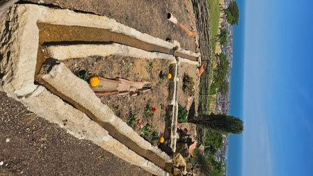 Aerial view of a landscaped garden area with ruins and a scenic view of the ocean.の写真素材