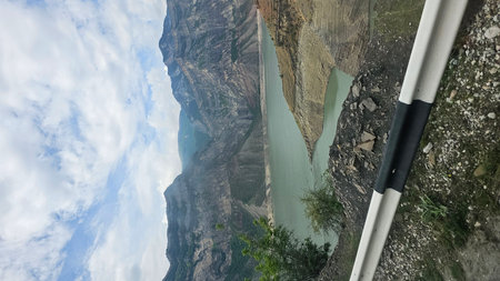Panoramic view from the train window to the mountains and blue skyの写真素材