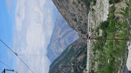 Climbing in the mountains. A man goes along the rope.の写真素材