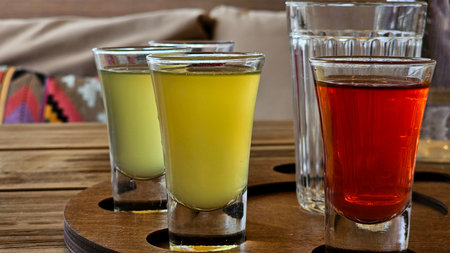 Craft Beer Flight on Barrel Wood Board
Description: Assortment of six local craft beers in tasting glasses with numbered coasters, served on repurposed barrel stave with pretzels aの写真素材