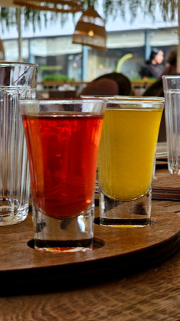 Rainbow Shots Arrangement with Fresh Berries
Description: Vibrant vertical composition of layered liqueur shots in crystal-clear glasses creating a color spectrum effect, garnishedの写真素材